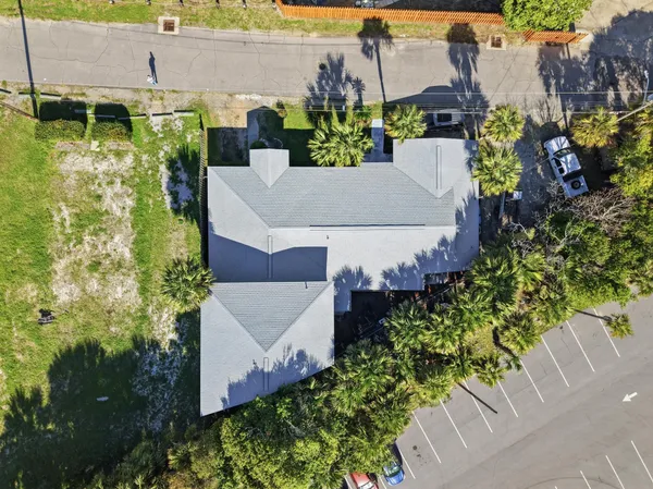 an aerial view of a house with a yard