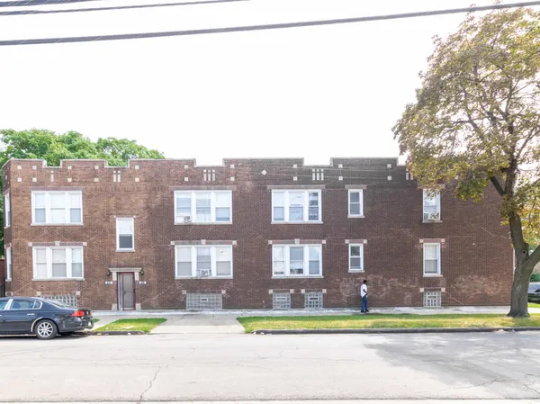a view of a building with a yard