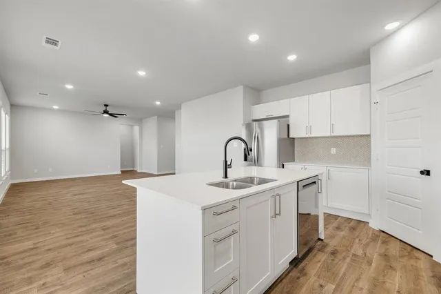 a kitchen with a sink stainless steel appliances and cabinets