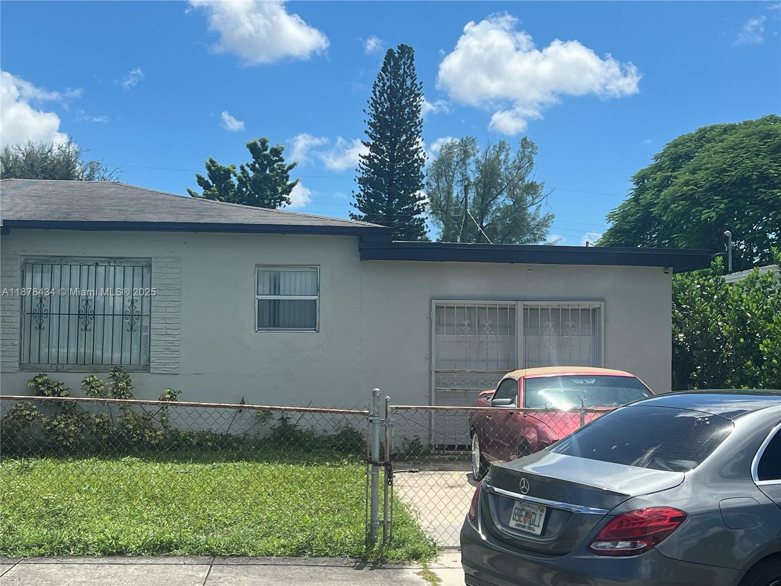 3100 Northwest 70th Street Miami, FL 33147 - Photo 2 of 5 a front view of a house with garden