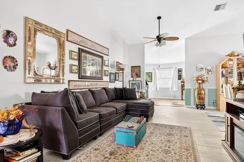 a kitchen with stainless steel appliances granite countertop a refrigerator a sink and white cabinets