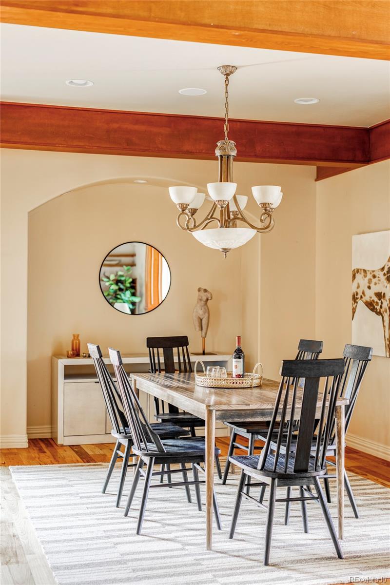 701 Leyden Street Denver, CO 80220 - Photo 13 of 42 a view of a dining room with furniture a chandelier and wooden floor