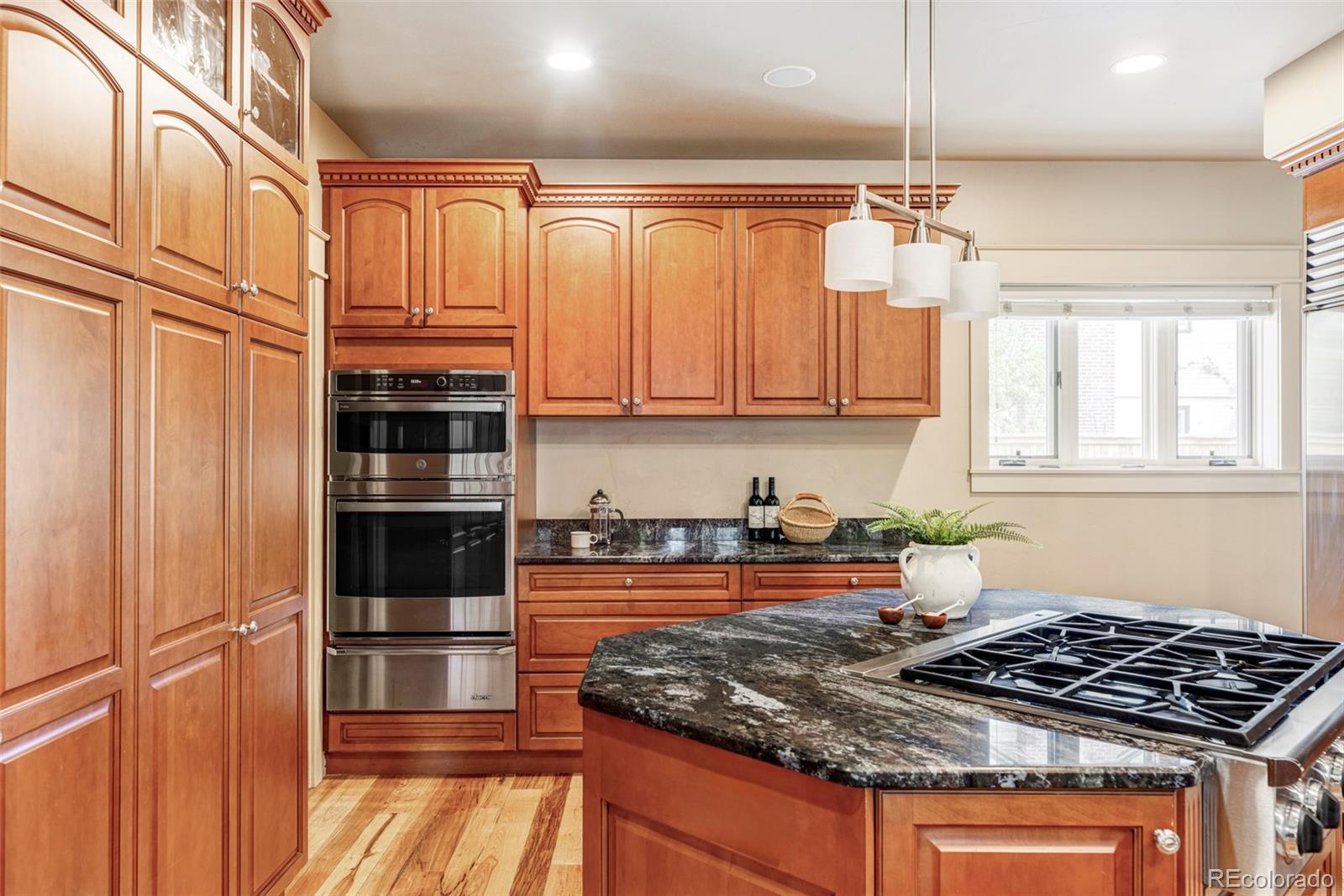 701 Leyden Street Denver, CO 80220 - Photo 17 of 42 a kitchen with granite countertop a stove and a refrigerator