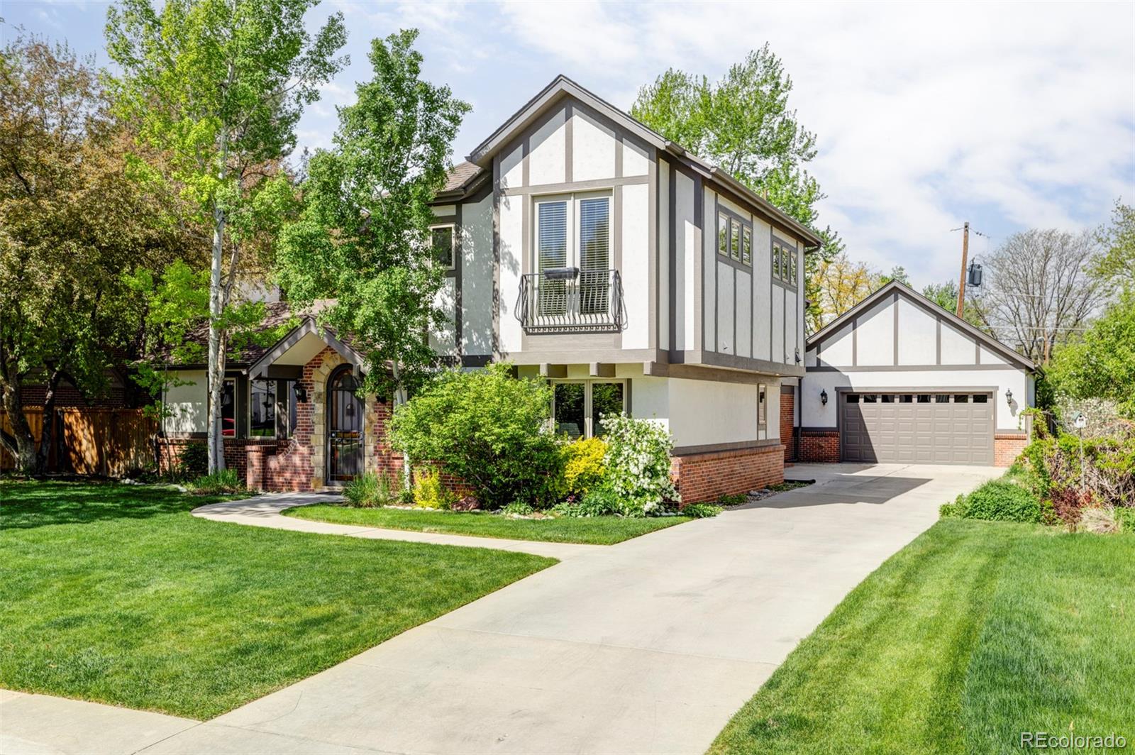 701 Leyden Street Denver, CO 80220 - Photo 2 of 42 a front view of a house with a yard and garage