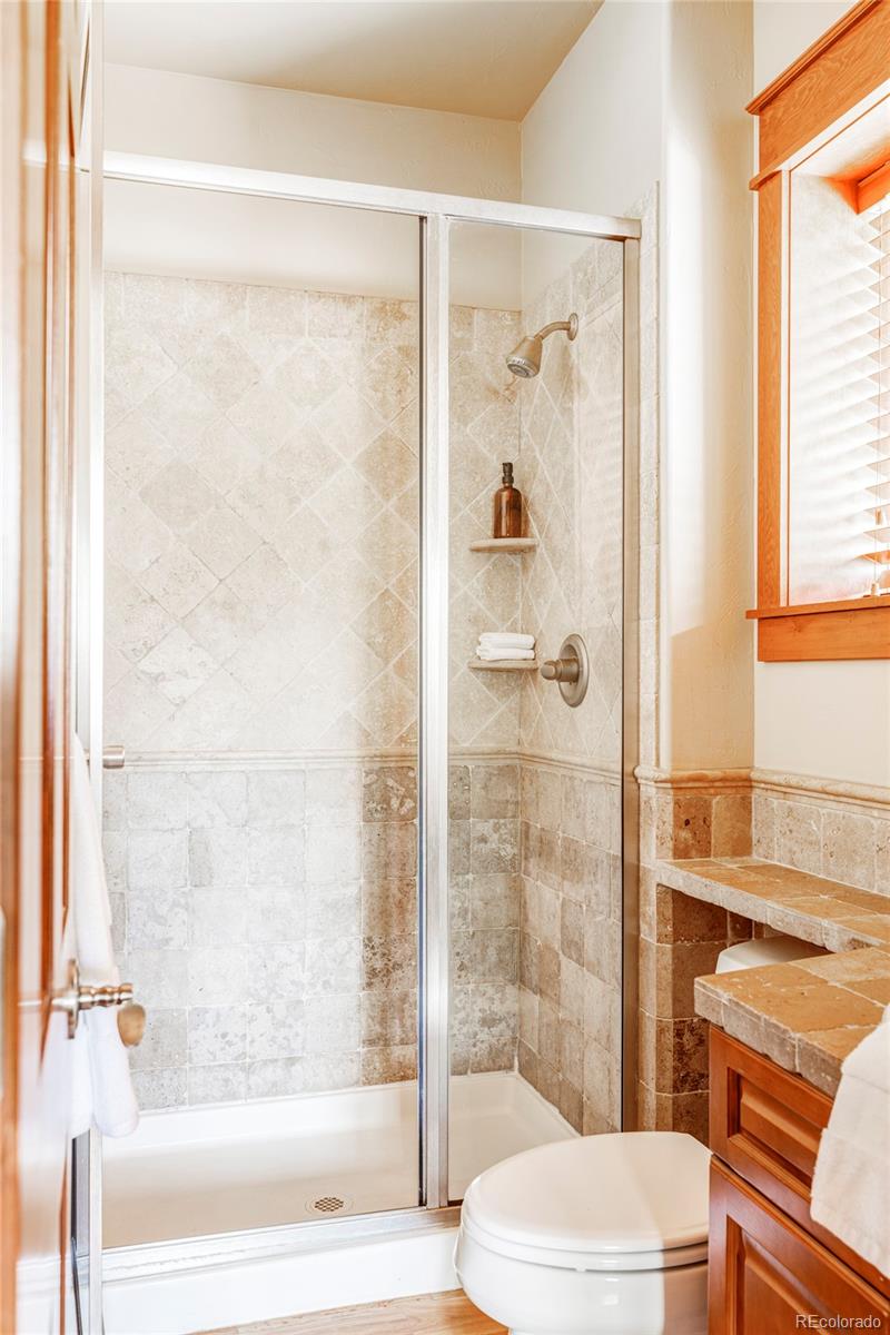 701 Leyden Street Denver, CO 80220 - Photo 24 of 42 a bathroom with a shower a toilet and a bathtub