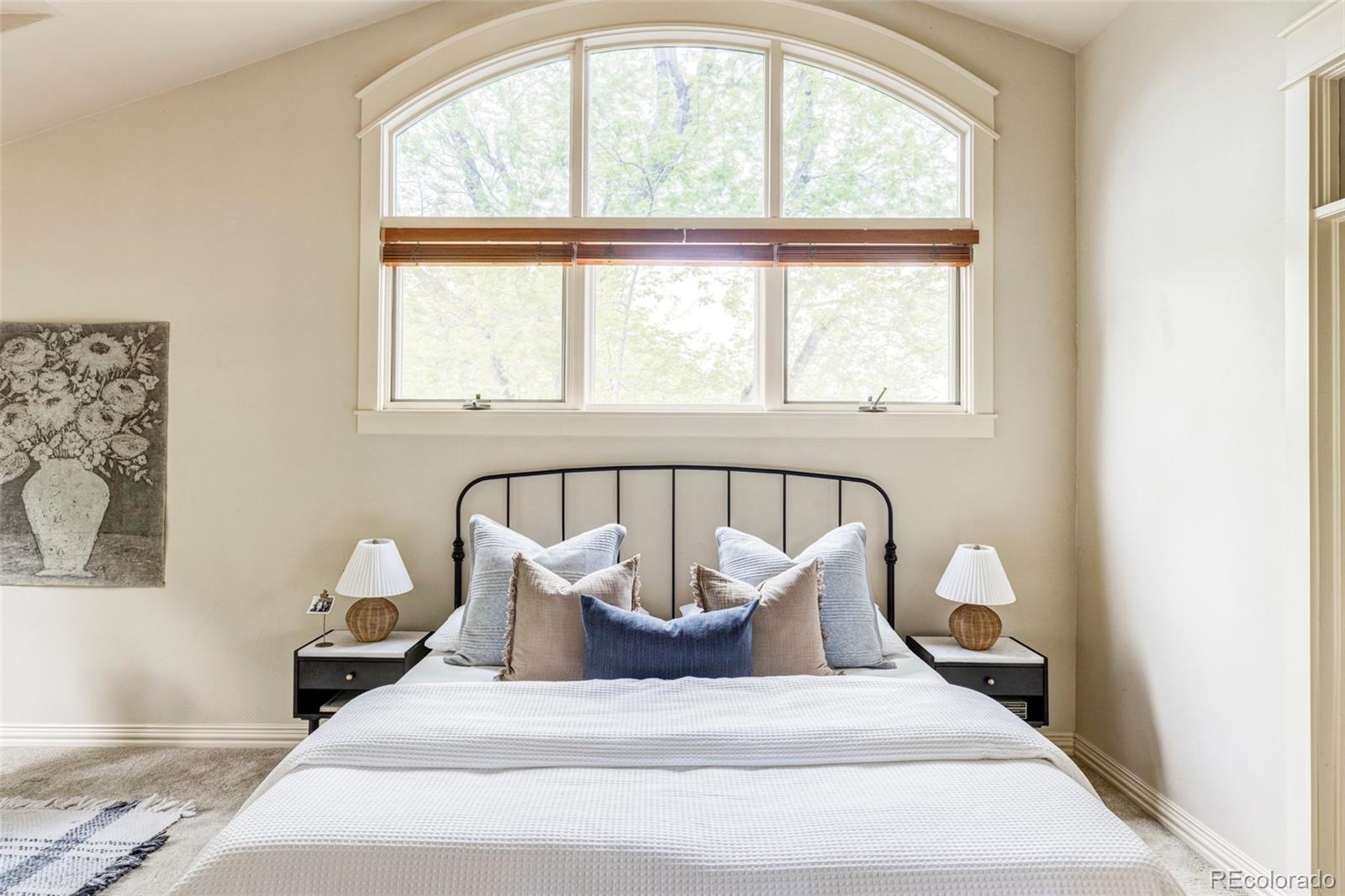 701 Leyden Street Denver, CO 80220 - Photo 27 of 42 a bed sitting in a bedroom next to a window