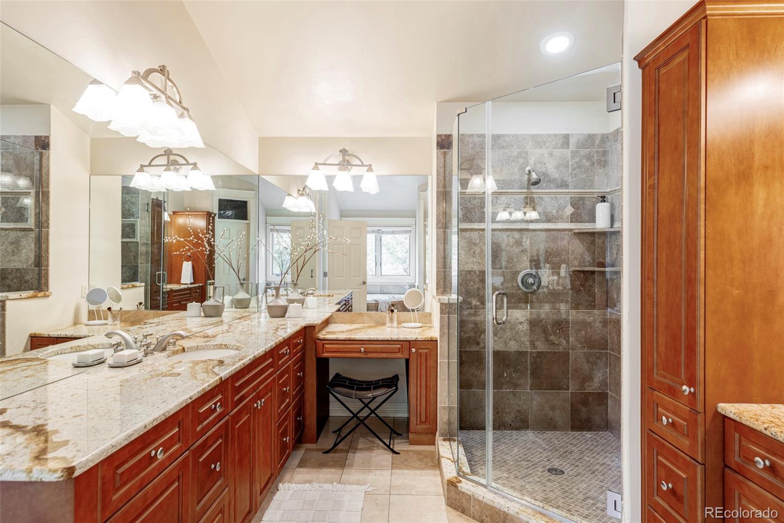701 Leyden Street Denver, CO 80220 - Photo 30 of 42 a bathroom with a double vanity sink mirror and shower
