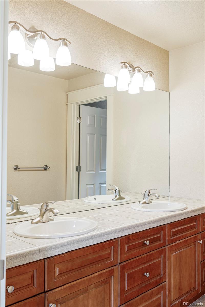 701 Leyden Street Denver, CO 80220 - Photo 33 of 42 a bathroom with a sink and a mirror