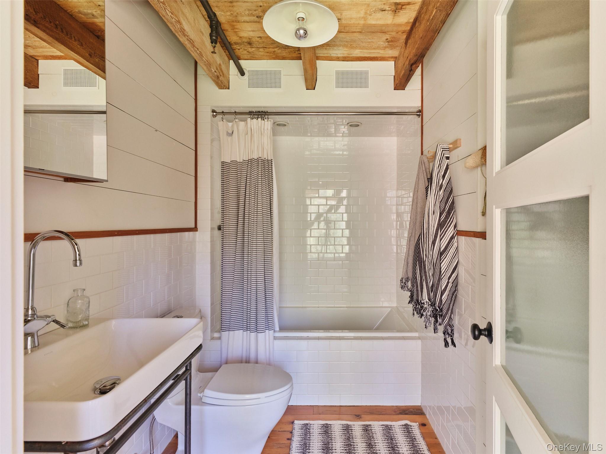 55 Woods Road Barryville, NY 12719 - Photo 34 of 50 a bathroom with a sink a toilet and a bathtub