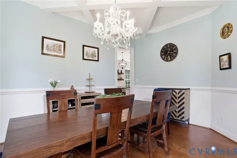 a dining room with furniture window and wooden floor