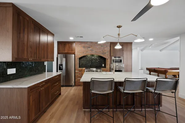a large kitchen with a table and chairs