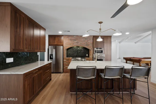 a large kitchen with a table and chairs