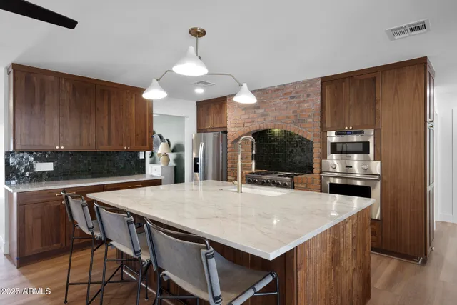 a kitchen with a table chairs refrigerator and cabinets