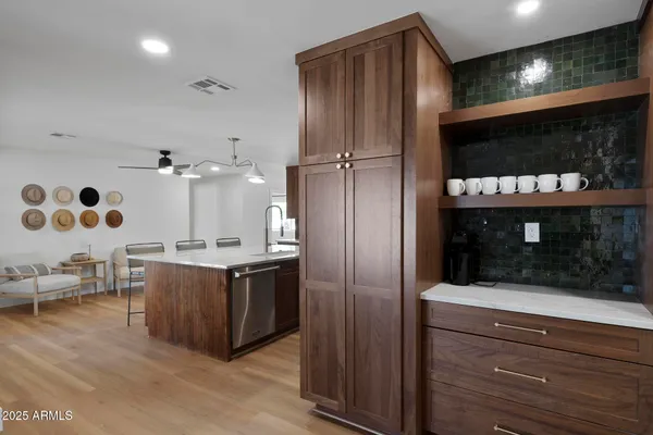 a kitchen with stainless steel appliances granite countertop a stove and a refrigerator