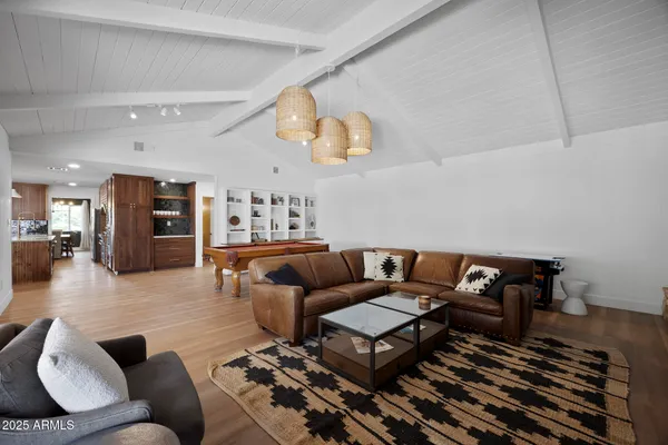 a living room with furniture and wooden floor