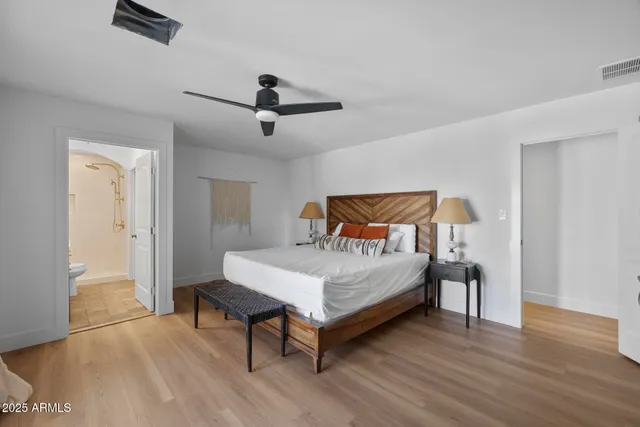 a bedroom with a bed and wooden floor