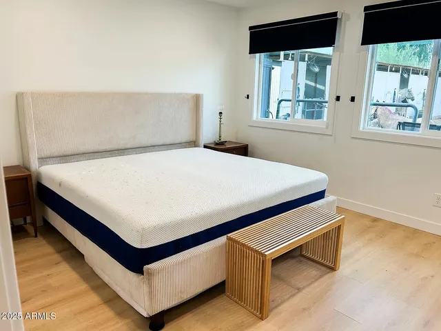 a bed sitting in a bedroom next to a window