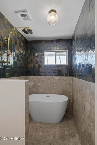 a spacious bathroom with a bathtub and window