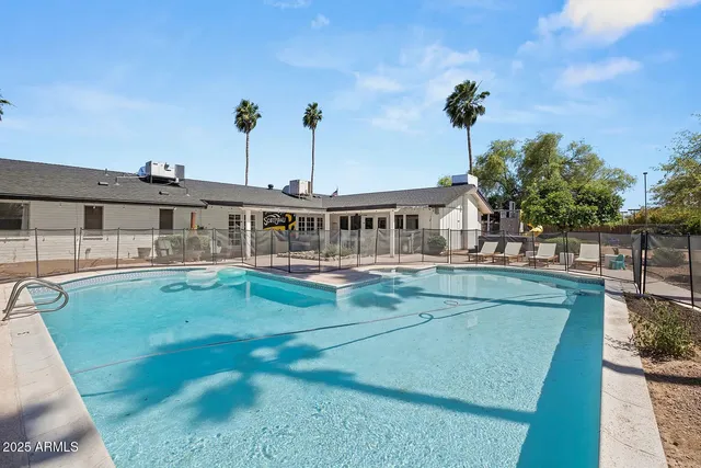 a view of a swimming pool with an outdoor seating