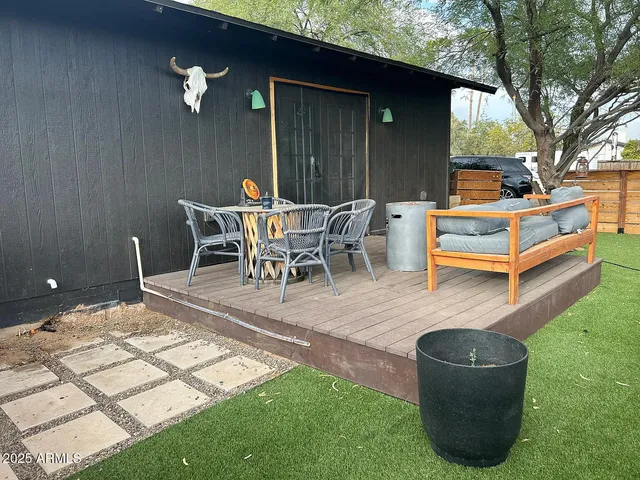 a backyard of a house with table and chairs