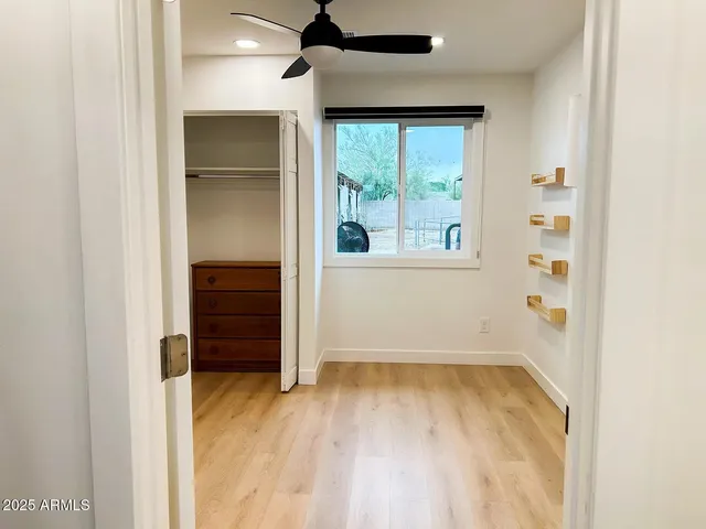 an empty room with windows and closet
