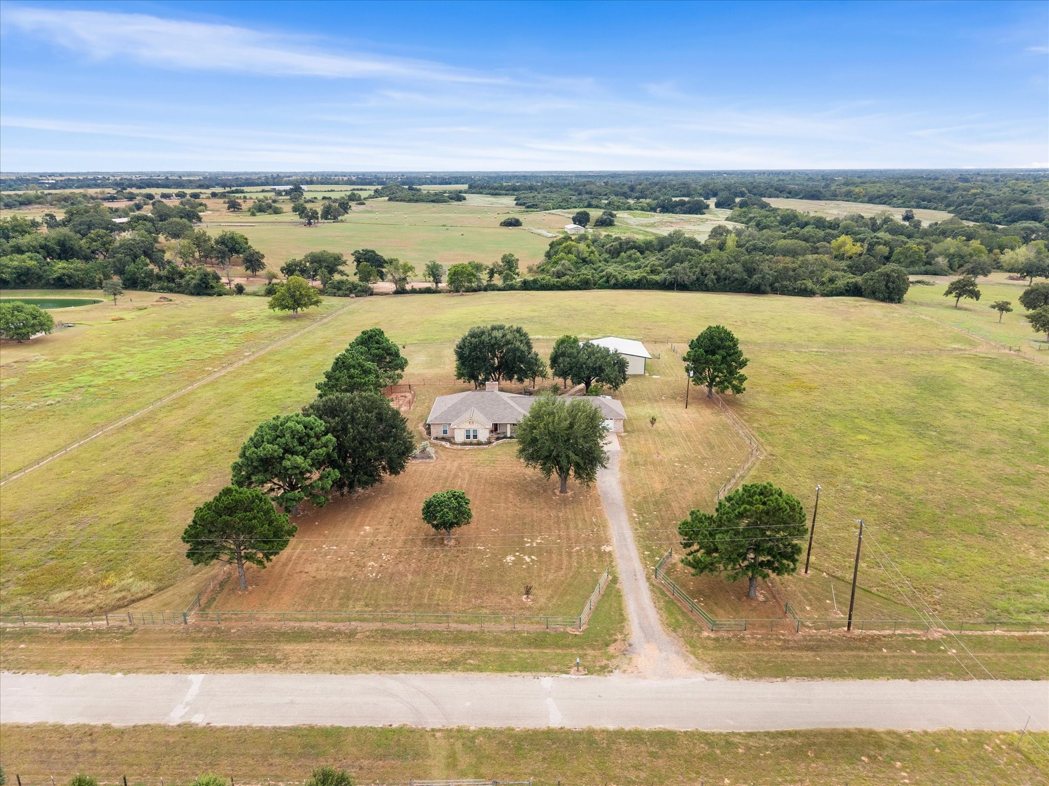 19929 Pierceall Road Hempstead, TX 77445 - Photo 4 of 50 Mature trees add shade and character to the fully fenced property, which is surrounded by large acreage tracts on all sides for a peaceful, private country setting.