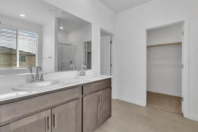 a bathroom with a double vanity sink mirror and double