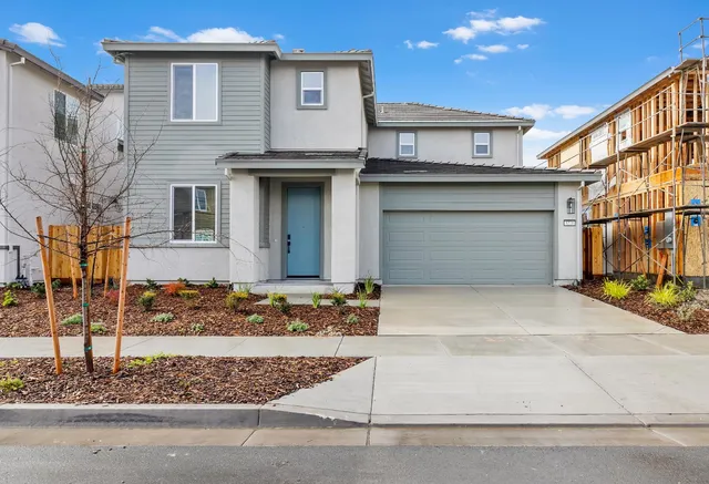 a front view of a house with garage
