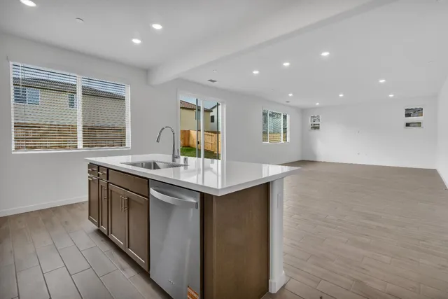 a kitchen with granite countertop a sink and a stove