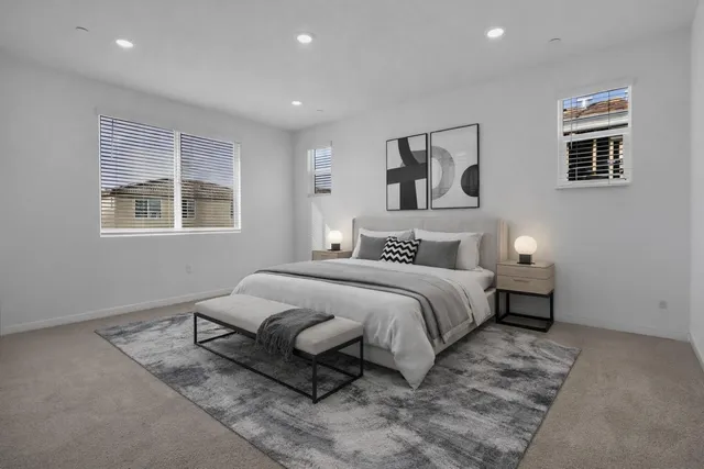 a spacious bedroom with a bed and wooden floor