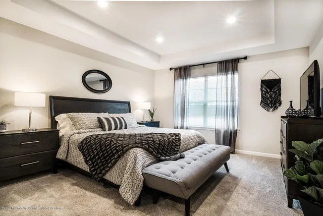 a bedroom with a bed a couch and dresser