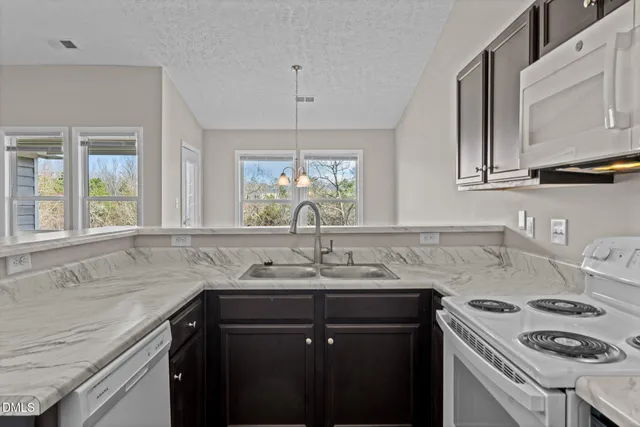 a kitchen with a sink stove and cabinets
