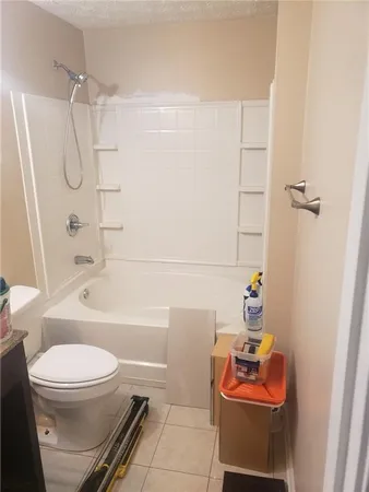 a bathroom with a toilet a sink and bathtub