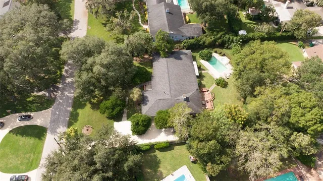 an aerial view of a house with swimming pool and outdoor space