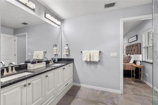 a spacious bathroom with a sink and a mirror