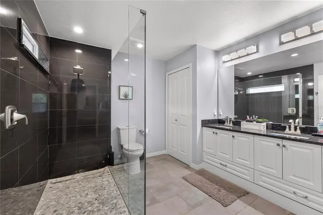 a bathroom with a sink a large mirror and a shower