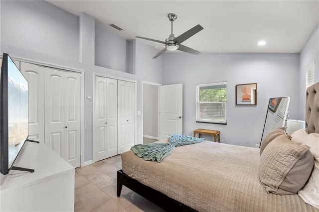 a bedroom with a bed and a chandelier