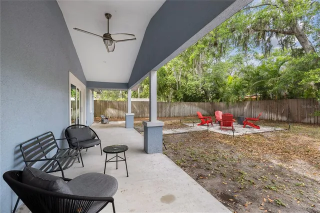 a view of a house with backyard and furniture