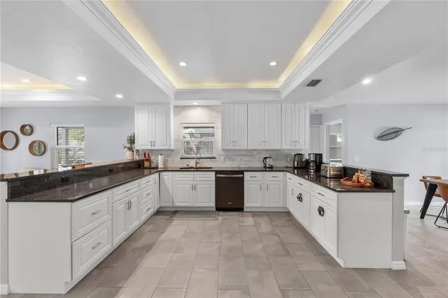 a kitchen with granite countertop a sink and cabinets
