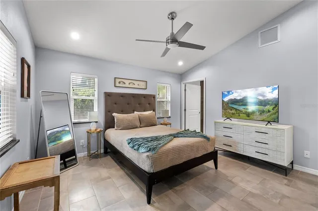 a bedroom with a bed and a flat screen tv