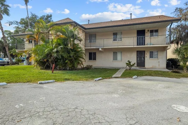 a view of a house with a yard and plants