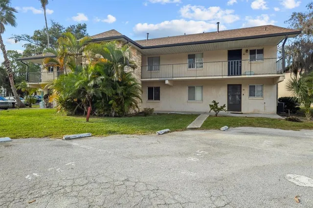 a view of a house with a yard and plants