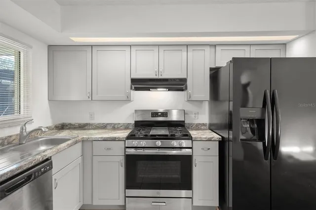 a kitchen with a stove microwave and refrigerator