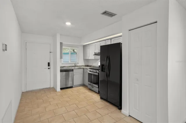 a kitchen with a refrigerator sink and stove