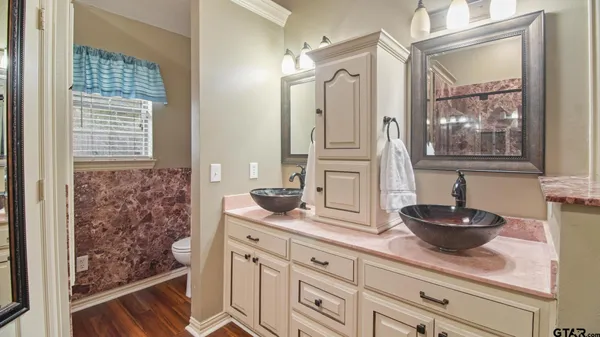 a bathroom with a sink a mirror and a window