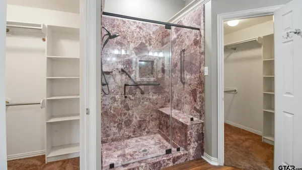 a bathroom with a glass shower door