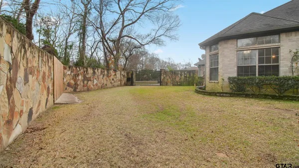 a view of house with yard and sitting area