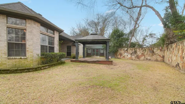 a house that has a tree in front of it