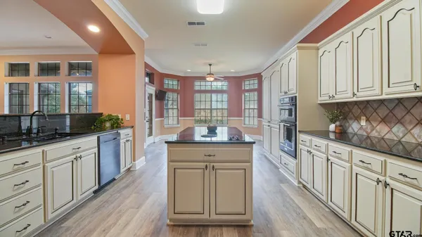 a kitchen with granite countertop a sink and cabinets