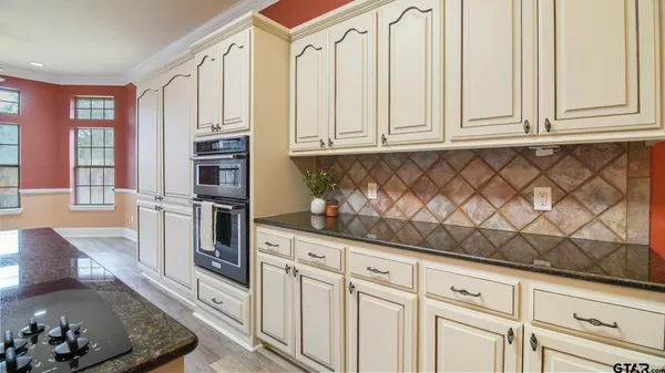 a kitchen with white cabinets and white appliances